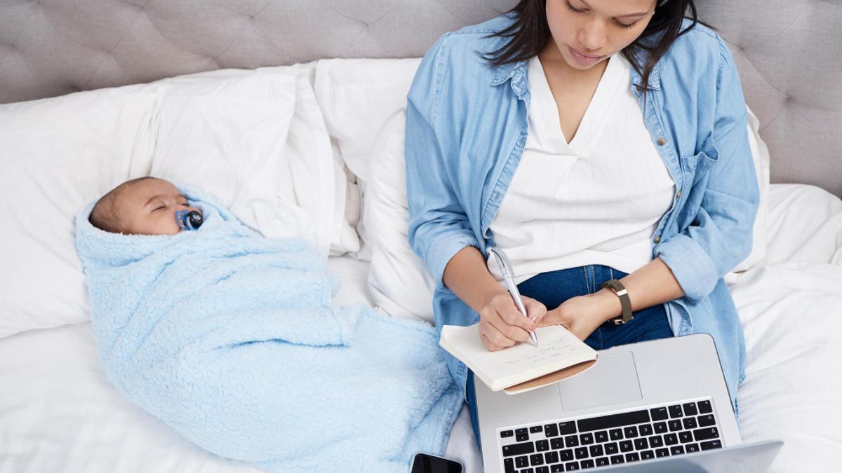 Femme enceinte travaillant sur son ordinateur depuis chez elle